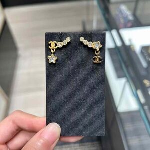 CHANEL Gold and Silver Star Logo Earrings